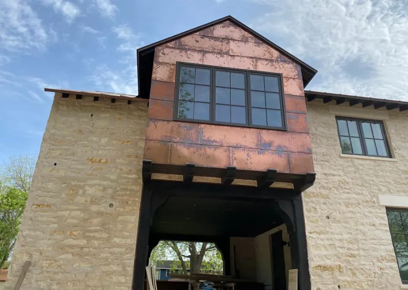 Copper metal panel facade on a stone building for Skylight Installation in Lewisboro